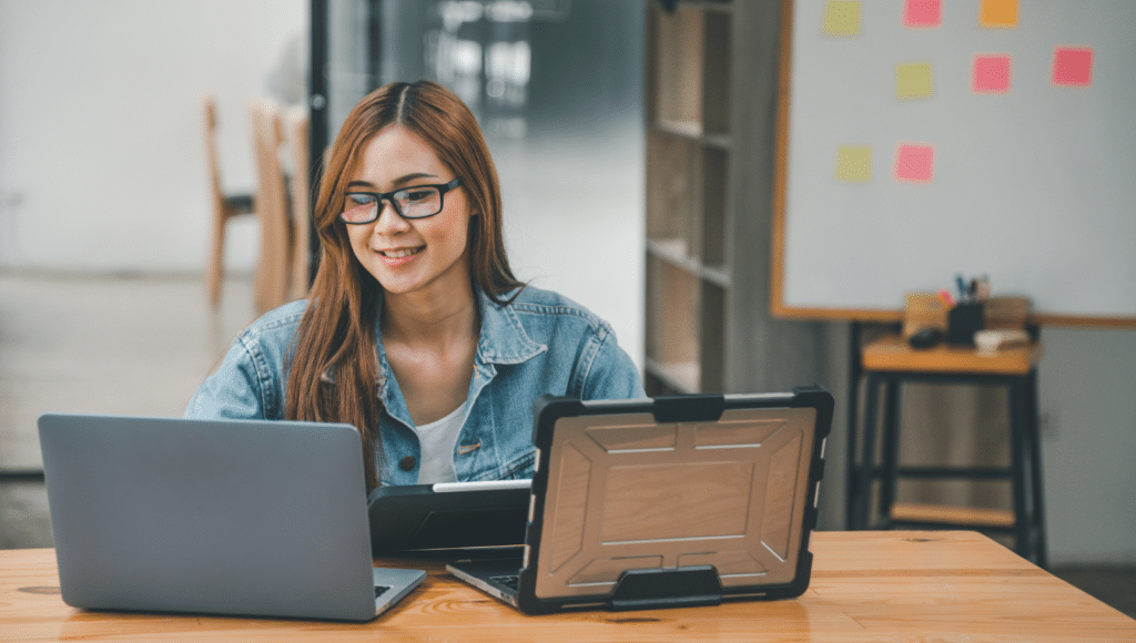 Exceptional Reliable Website Hosting In St Louis Smes: Stress-Free And Secure 4 A Woman Sitting At A Table With A Laptop And A Tablet Ask Us. Https://Websitedesignstlouis.com