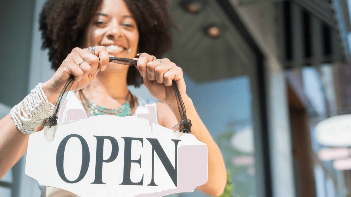 A Woman Holding An &Quot;Open&Quot; Sign Email Us At Getmysite@Websitedesignstlouis.com