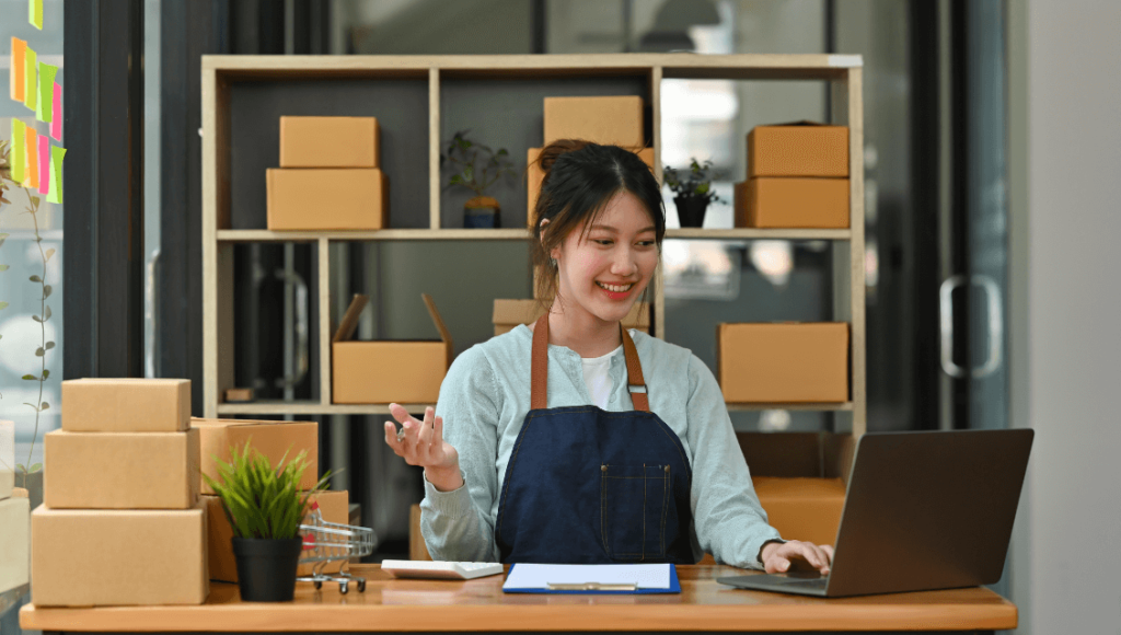 Why A Professional Website Is Crucial For Your Business Success 2 A Business Woman In An Apron Sitting At A Desk With A Laptop Https://Websitedesignstlouis.com/