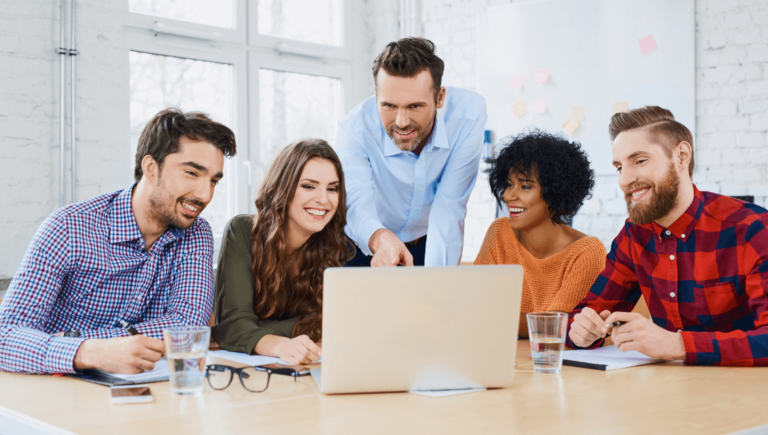 A Website Design Team Looking At A Laptop Https://Websitedesignstlouis.com/