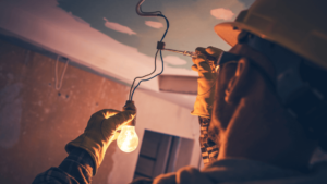 A Man Holding A Light Bulb
