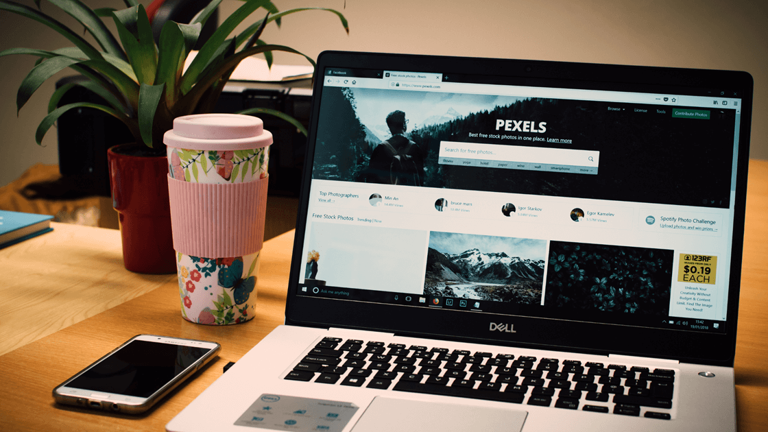 A Laptop On A Desk With A Flask And Cellphone On The Left Side Email Us At Getmysite@Websitedesignstlouis.com